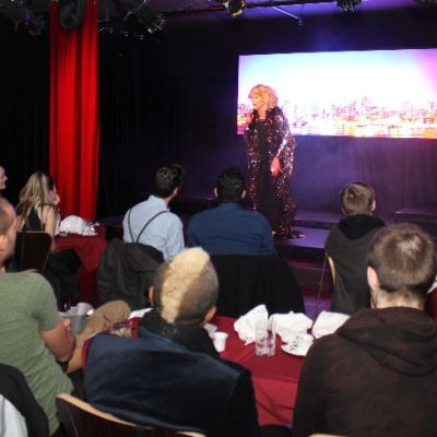 a group of people sitting on a stage in front of a crowd