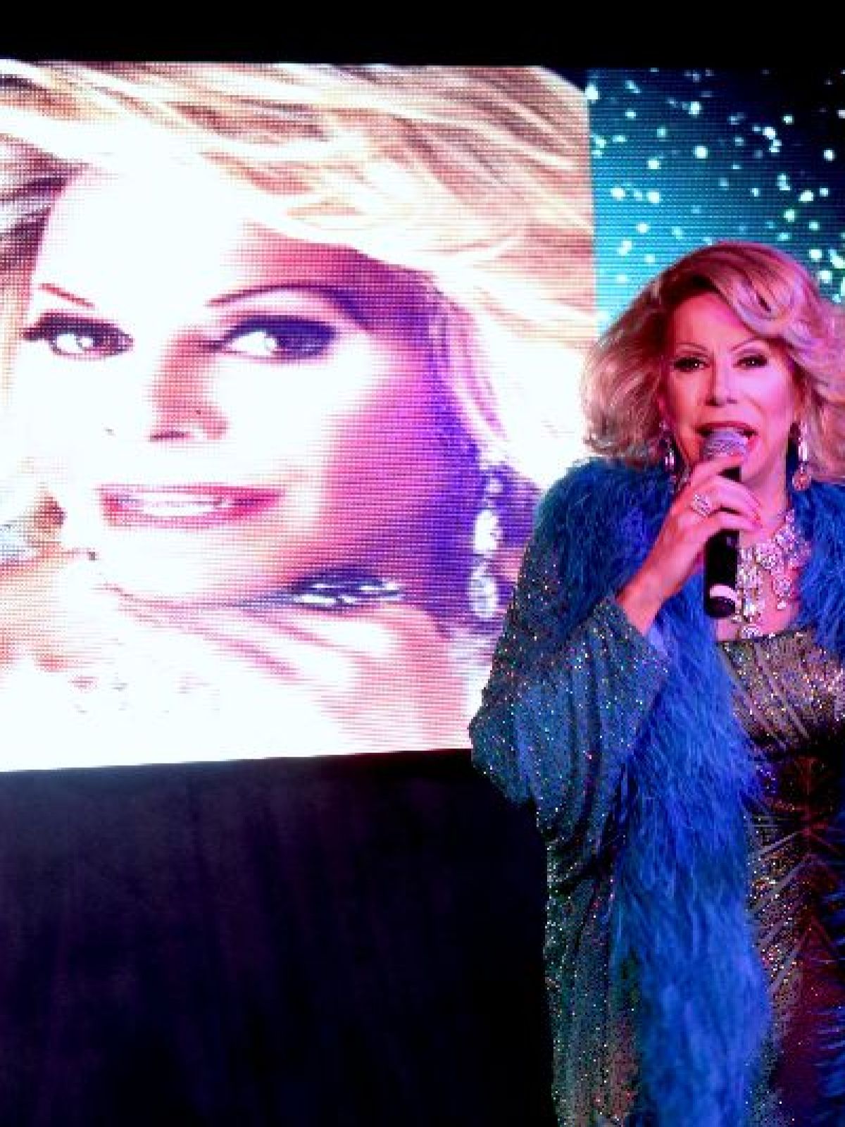 Nil Burak wearing a blue screen